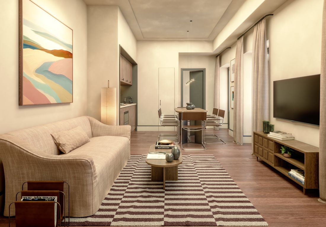Sala moderna con sof&aacute; beige, alfombra a rayas y comedor al fondo.