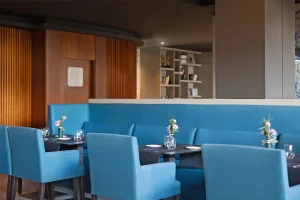 Cozy atmosphere in a restaurant with blue seating and flowers