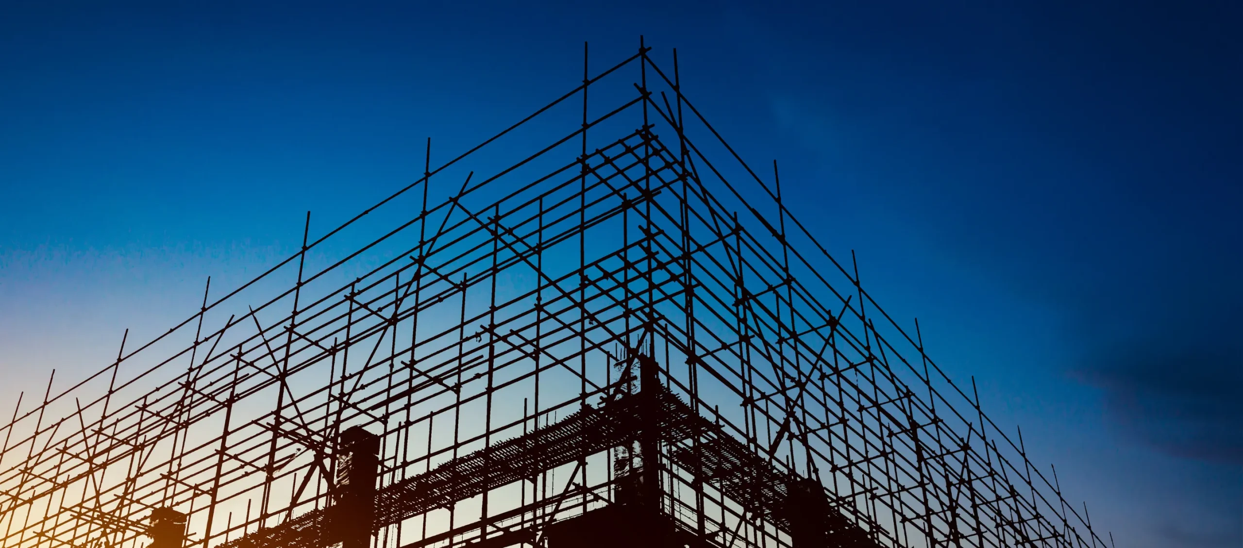 Detailed view of scaffolding on a construction site during sunset