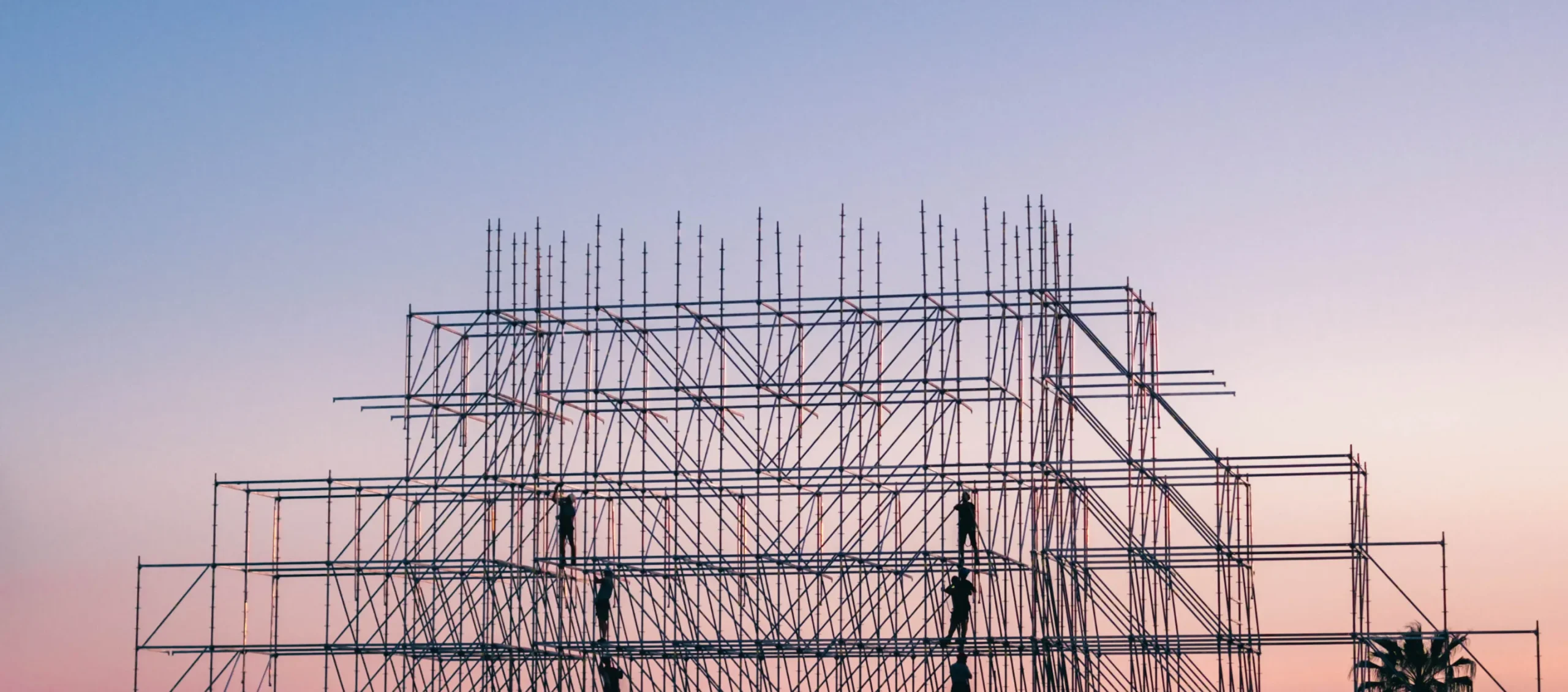Scaffolding structure against a sunset sky