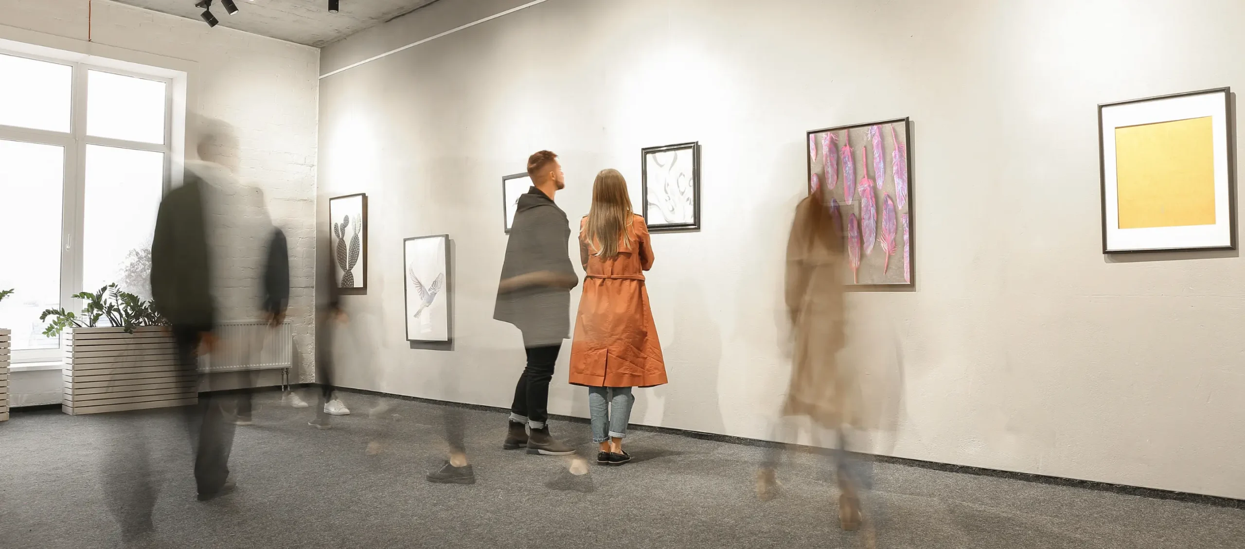 Visitors admiring artwork in a contemporary art gallery