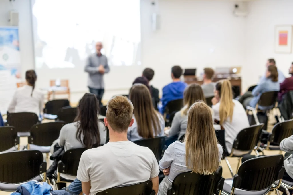 Audience listening attentively at a conference presentation