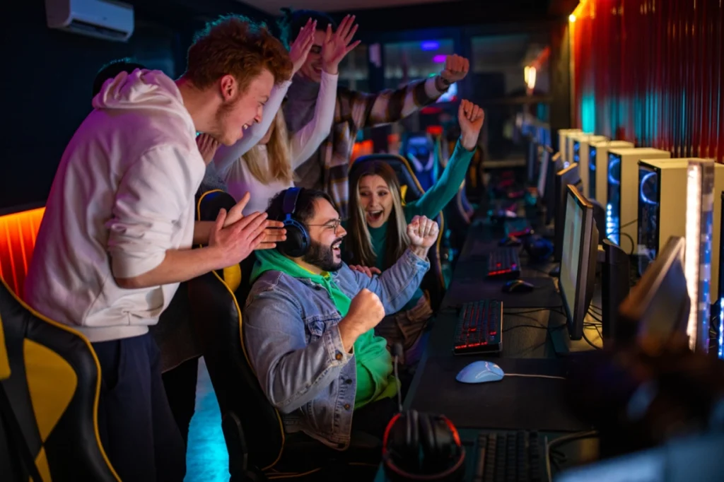 group of friends celebrating a video game win