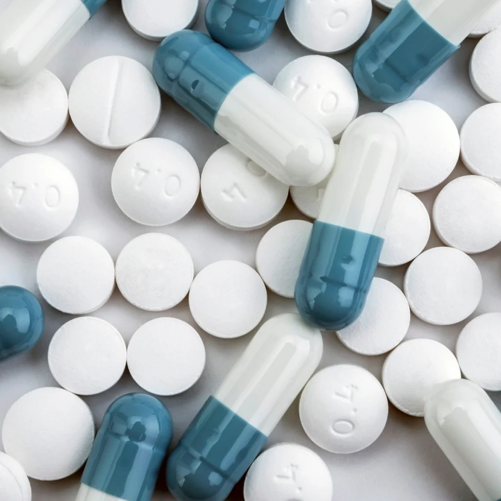 Mixed capsules and tablets arranged on a flat surface