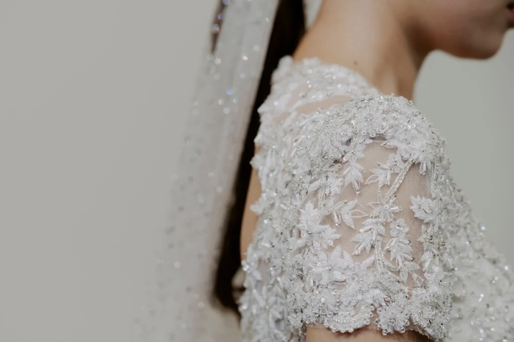 Close-up of intricate embroidery on bridal dress sleeve