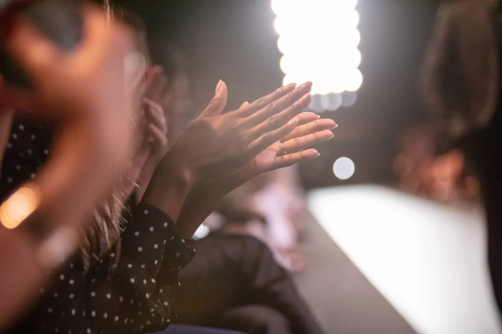 Hands applauding at a fashion show event