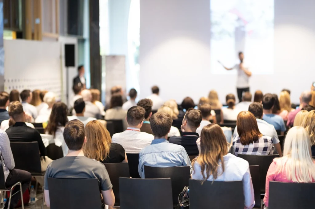 Audience attentively listening to a speaker at a conference