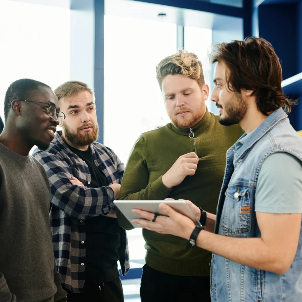 Young professionals collaborating and brainstorming ideas with a tablet