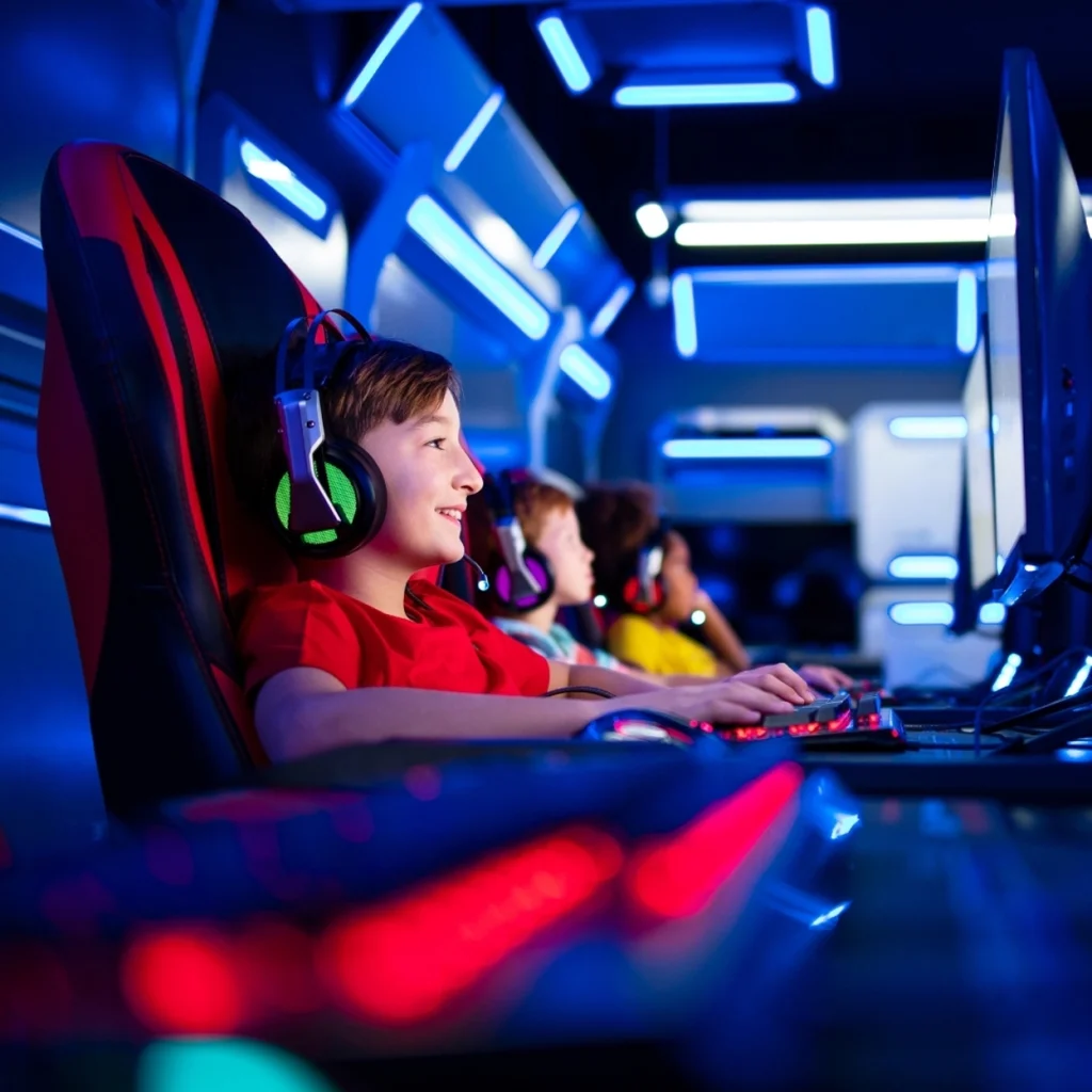 Children enjoying video games in an illuminated environment.