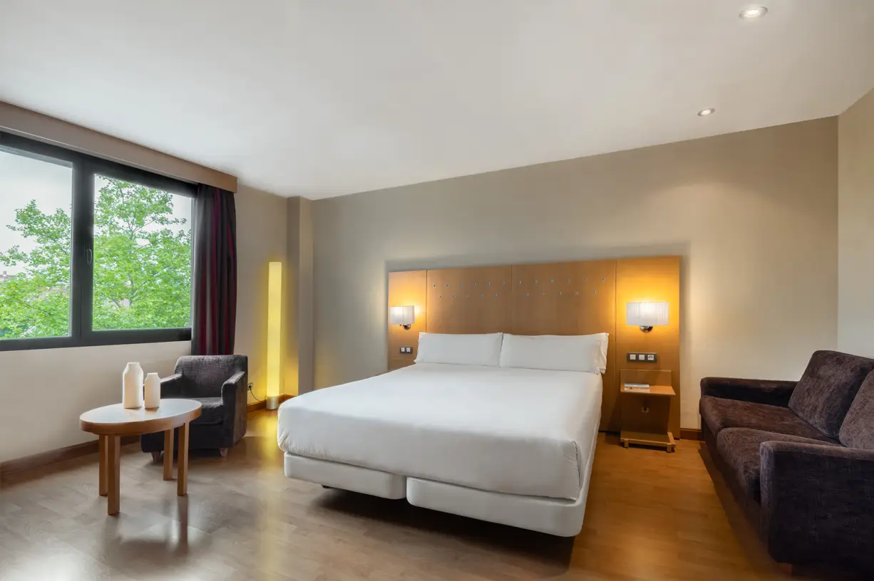 Modern hotel room with double bed and desk