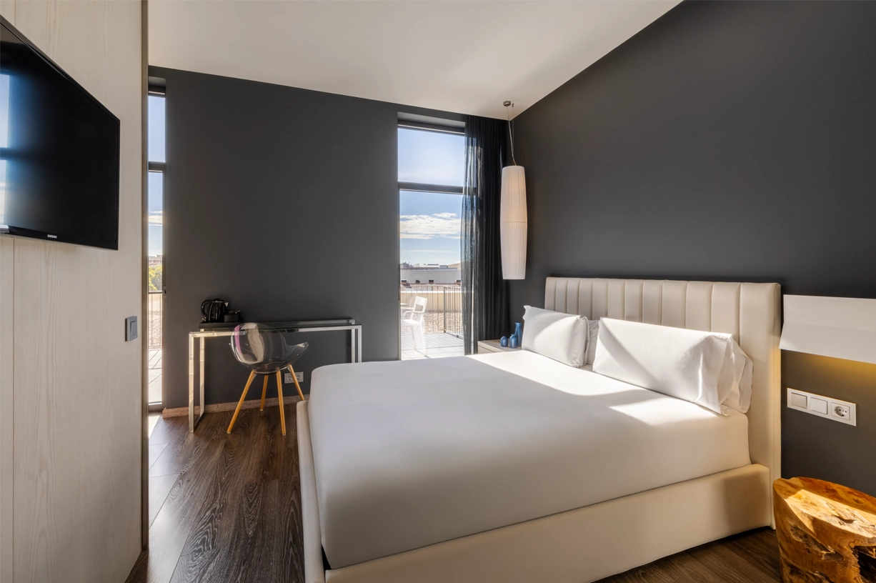 A modern room with a large bed and a view