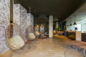 A modern lobby featuring stylish hanging chairs and elegant decor.