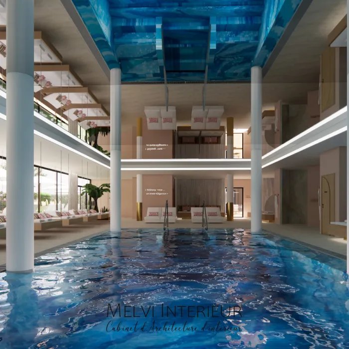 Piscine int&eacute;rieure luxueuse avec mezzanine et canap&eacute;s modernes.