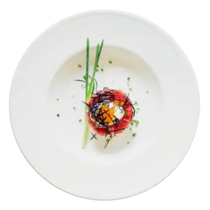 A gourmet dish on a white plate, garnished with herbs and a colorful topping.