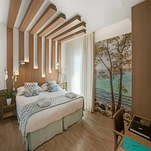 Modern bedroom with wooden accents and a sea-view mural wall.