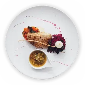 Gourmet dish with sauce, vegetables, and a meat garnish on a white plate with artistic drizzle.