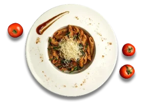 Pasta with grated cheese, sauce, and herbs on white plate, surrounded by cherry tomatoes.
