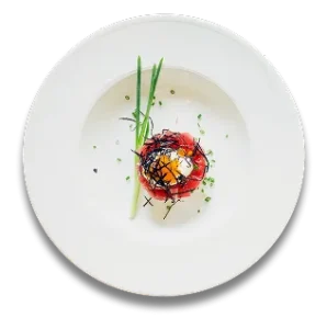 Gourmet dish with seafood, garnished with herbs on a white plate.