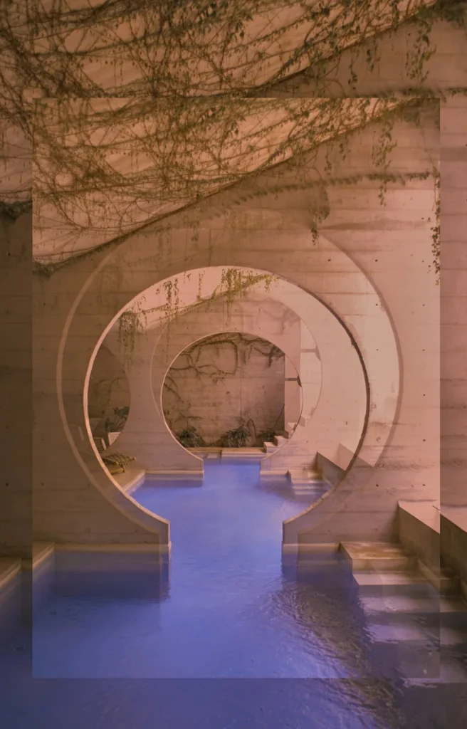 Indoor courtyard pool framed by arched tunnel, with vines overhead.