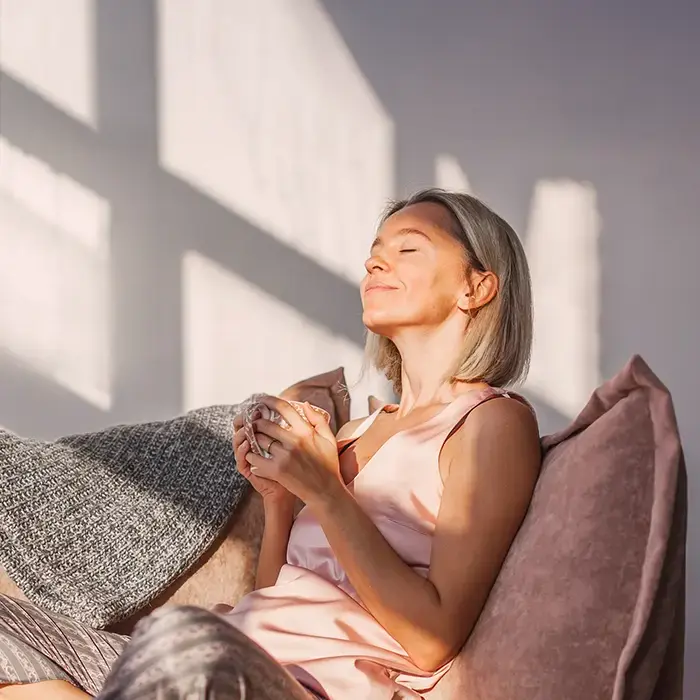 Relaxed woman with a cup of coffee in her hands