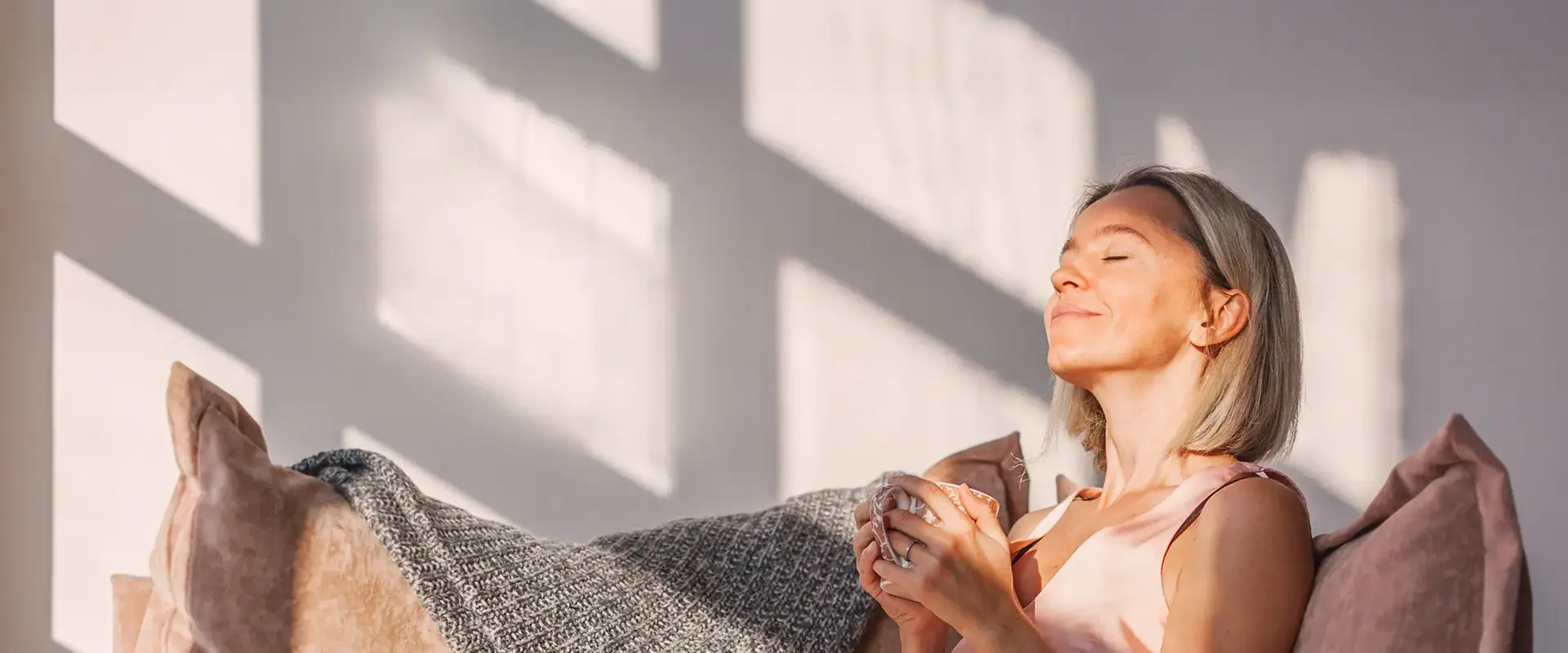 Relaxed woman with a cup of coffee in her hands