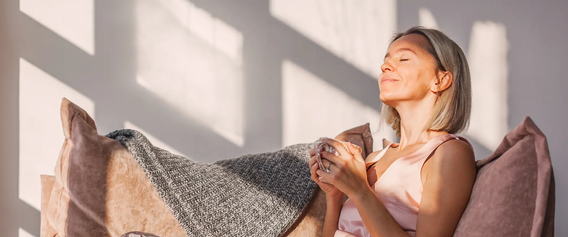 Relaxed woman with a cup of coffee in her hands