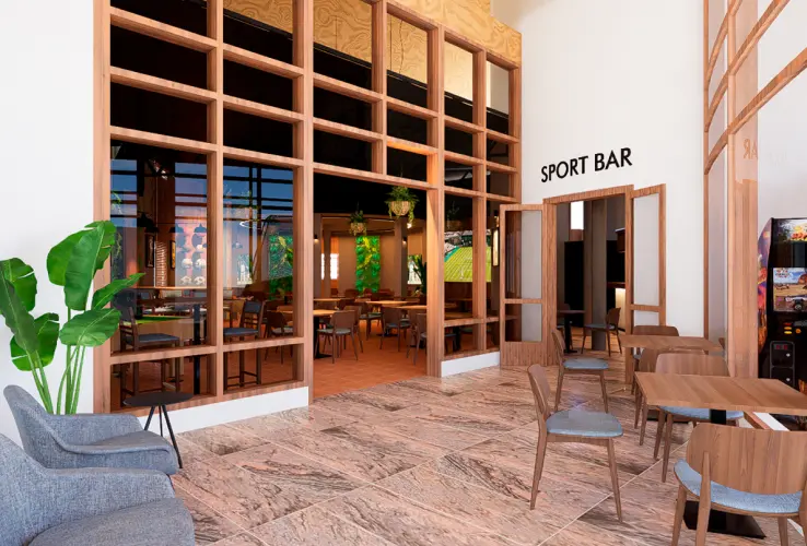 Entrada de un sport bar con mesas y sillas modernas, una planta decorativa y un letrero en la pared.