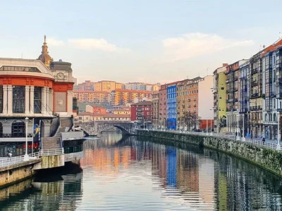 Vista de un canal rodeado de edificios coloridos bajo un cielo despejado.