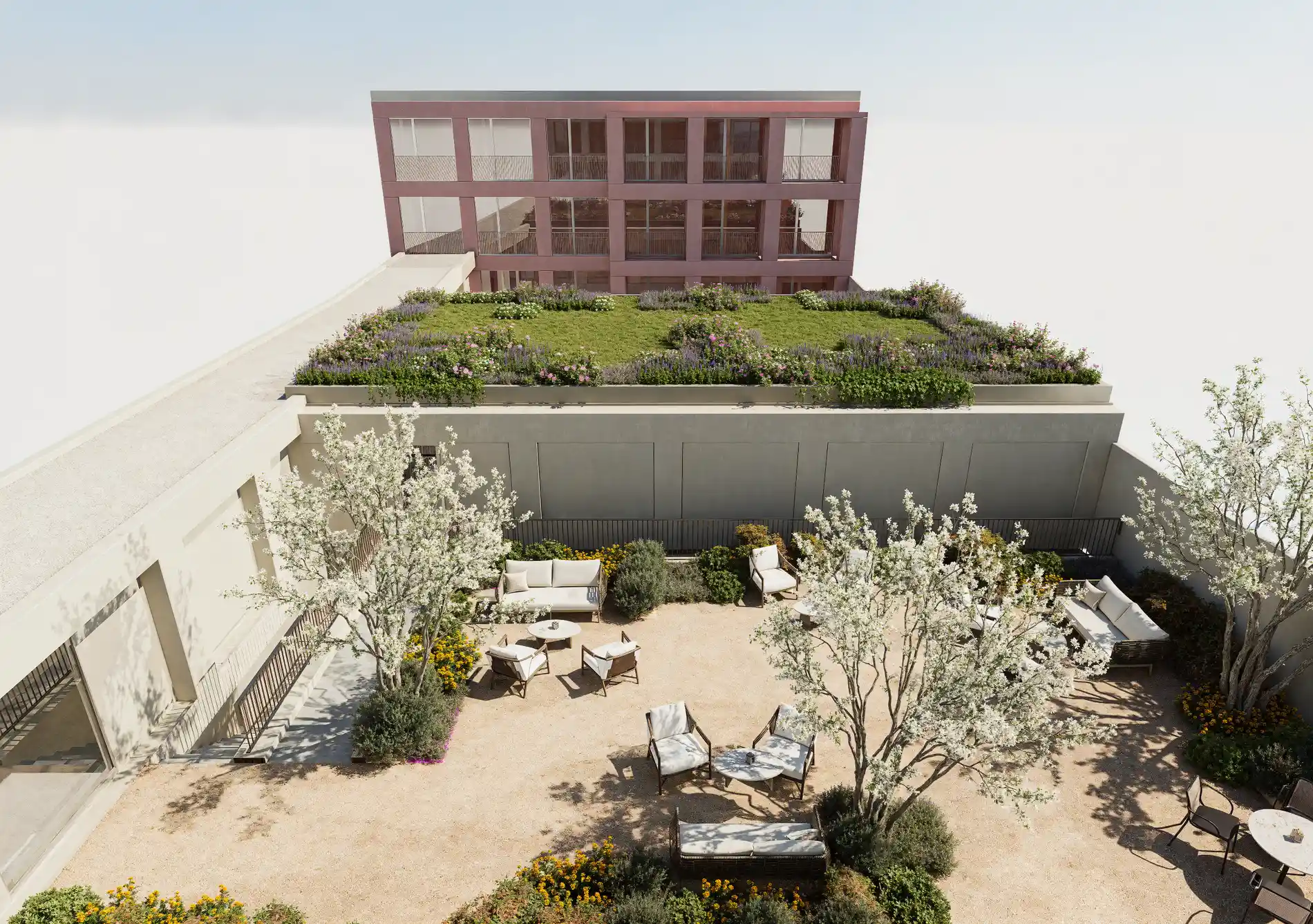 Rooftop garden with seating, trees, and plants in a courtyard setting, under a clear sky.