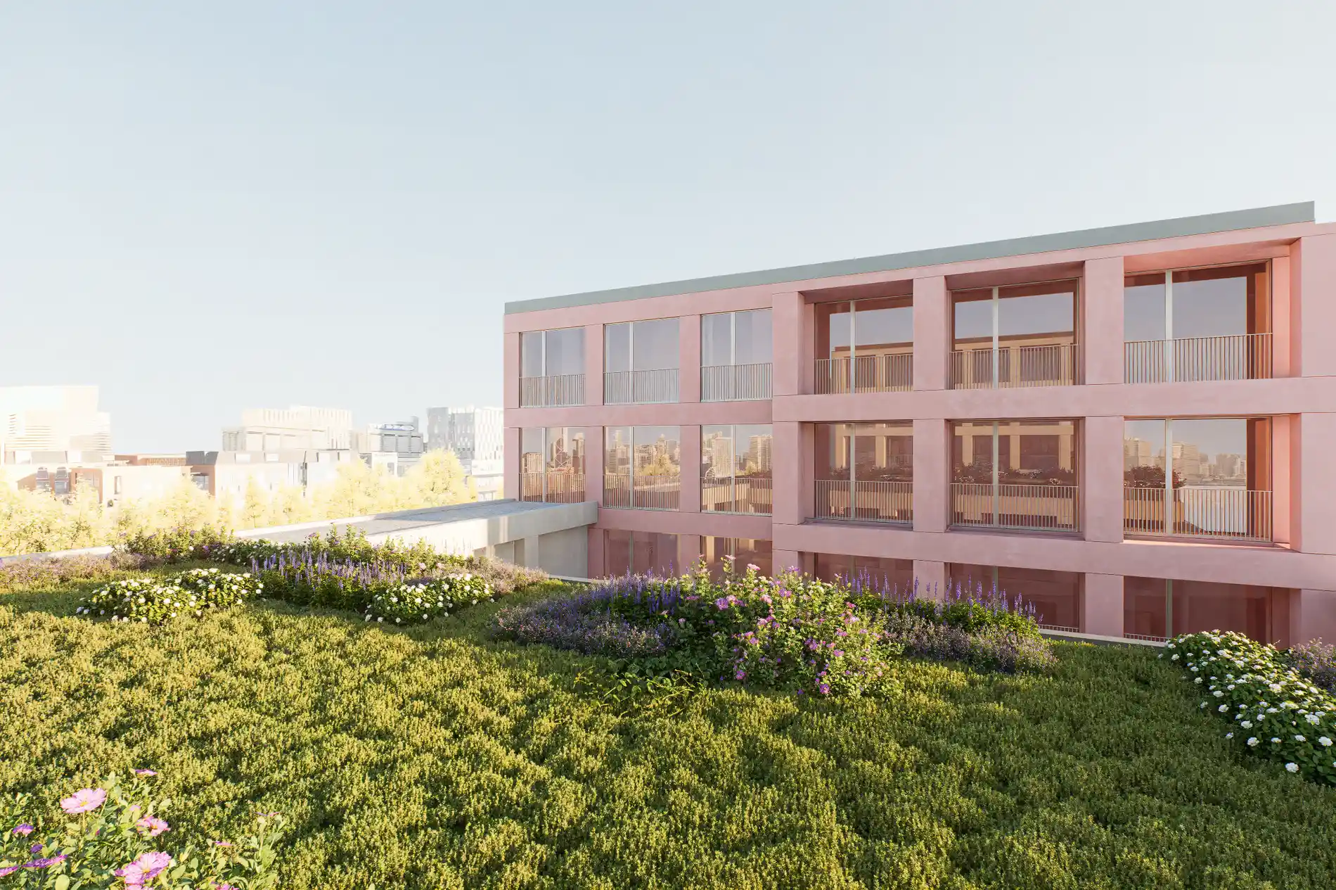 Modern pink building with lush rooftop garden and urban skyline in the background.