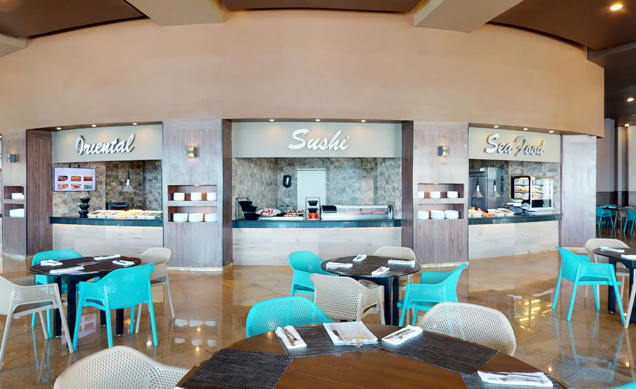 Buffet area with "Oriental," "Sushi," and "Sea Food" stations. Tables and turquoise chairs in the foreground.