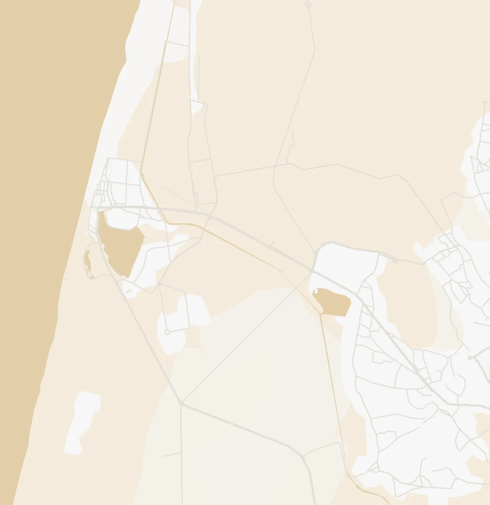 Minimalistic map with beige and tan shades, showing roads and a coastline on the left.