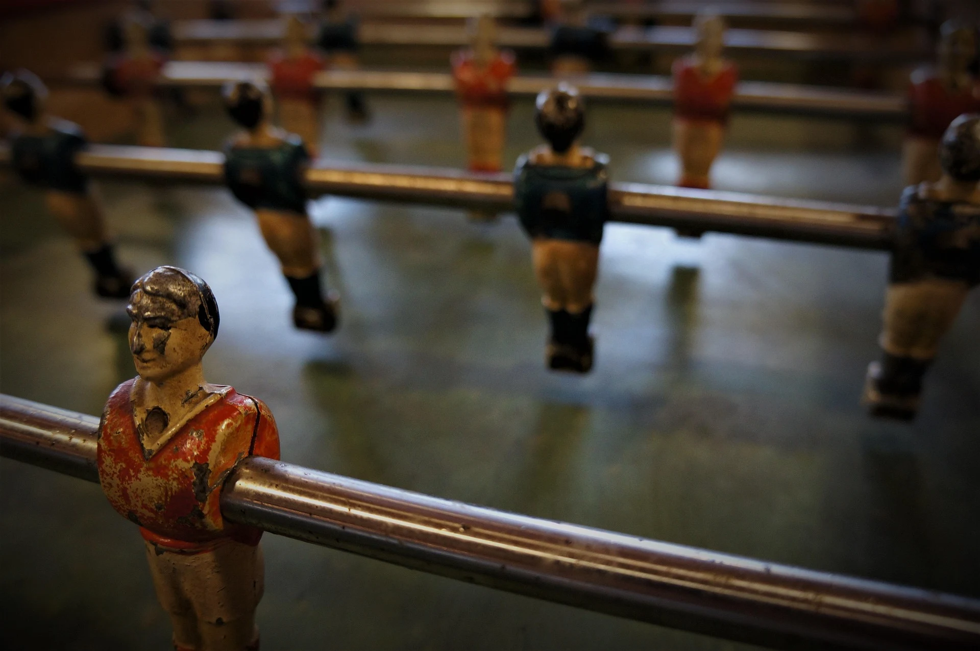 Close-up of vintage foosball figure on a metal rod.