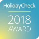 HolidayCheck 2018 Award logo on a blue gradient background.