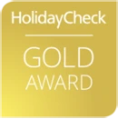 HolidayCheck Gold Award logo on a gold background.