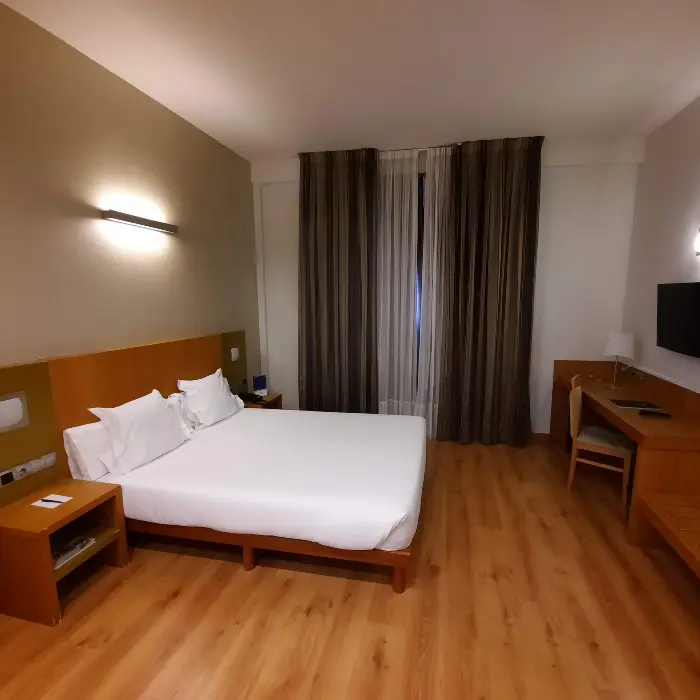 foto habitacion superior, cama mesita de noche y escritorio