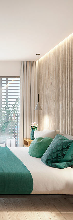 Habitación moderna con cama, cojines verdes, lámpara colgante y ventana con cortinas.