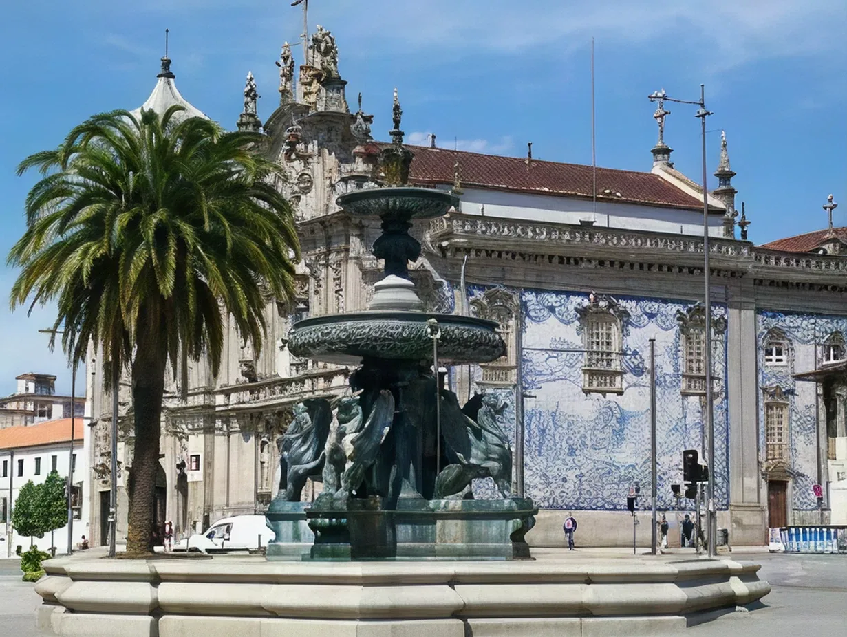 Fountain and palm tree in front of ornate building with blue tile facade.