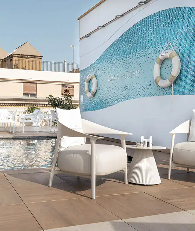 Piscina en la terraza de Casa Fuster con sillas modernas y mesa peque&ntilde;a.