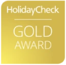HolidayCheck Gold Award logo on a gold background.