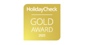Placa dorada con el texto "HolidayCheck Gold Award 2025".