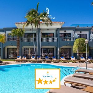 Piscina de un hotel con tumbonas y palmeras, destacando una insignia de hotel de cinco estrellas.