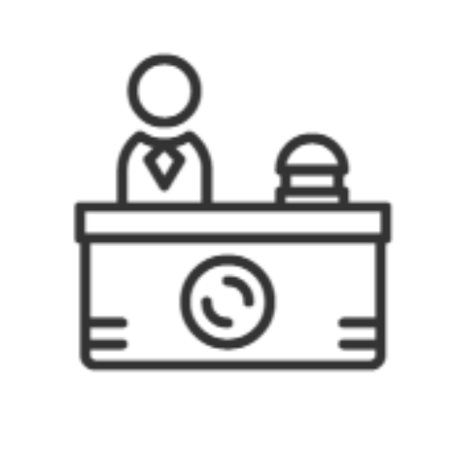 Icône de réceptionniste derrière un bureau avec une sonnette.