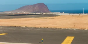 Tenerife South Airport runway with Red Mountain in the background.