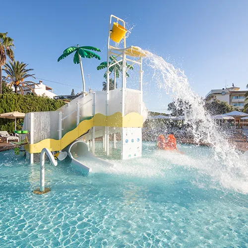 Parque acu&aacute;tico infantil con toboganes y cubo de agua en una piscina.
