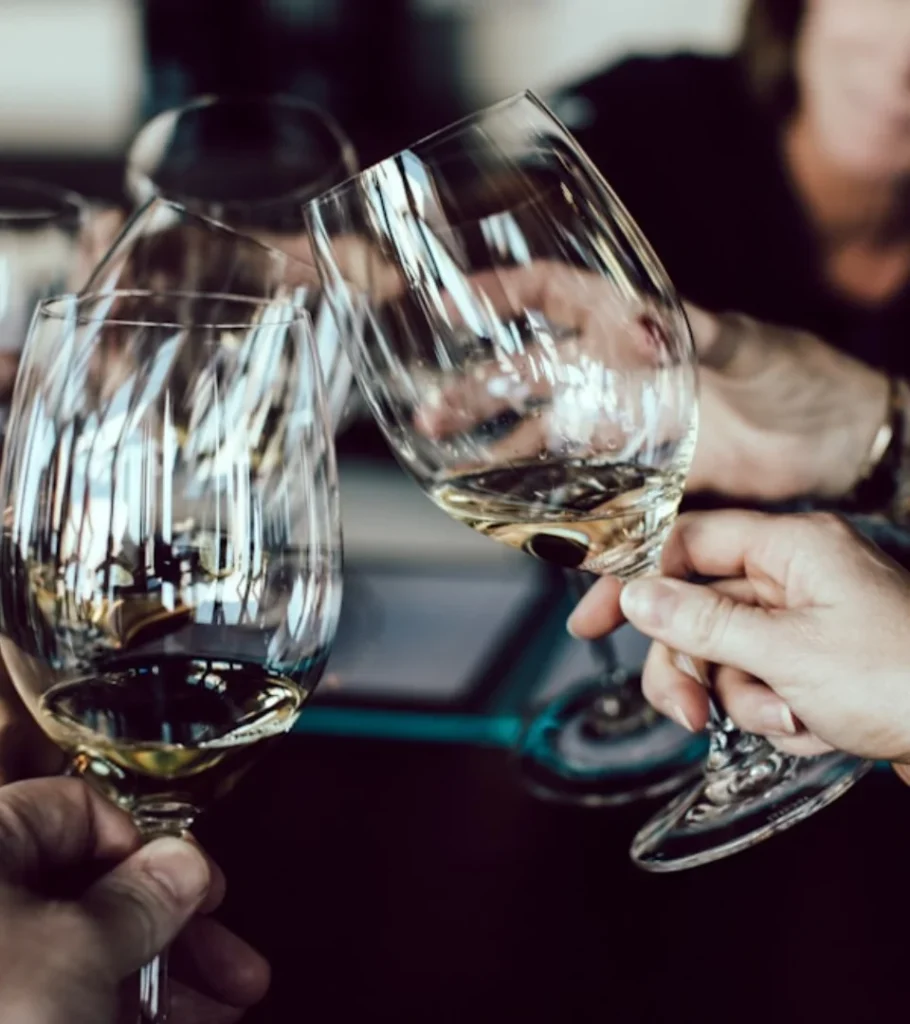 Copas de vino chocando en un brindis amistoso.