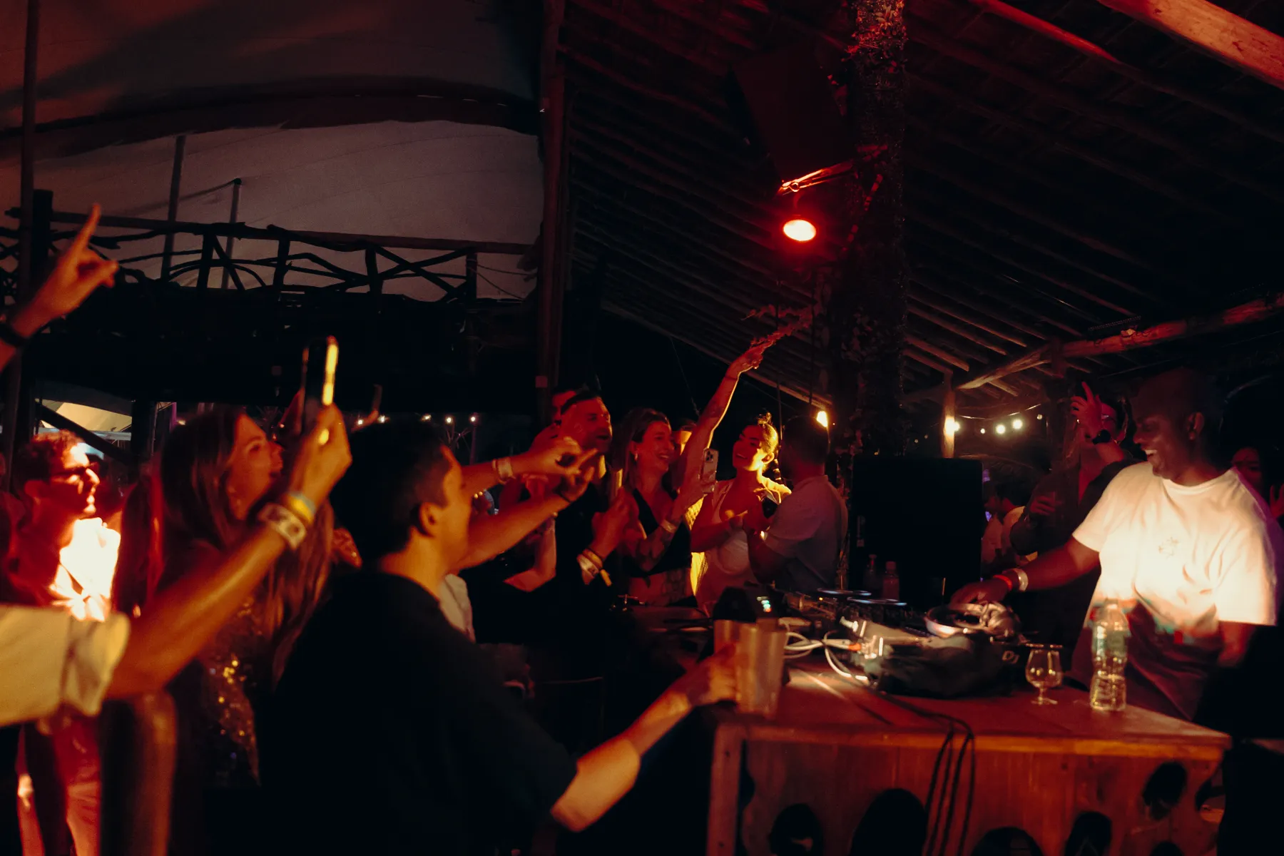 Personas disfrutando música en vivo bajo luces cálidas en un evento nocturno.