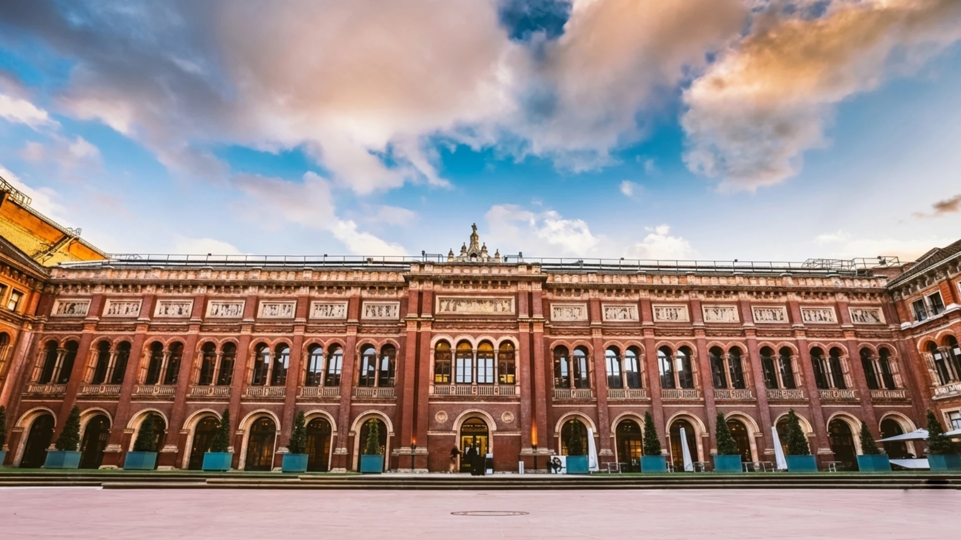 Historic building with arches under a vibrant sky.
