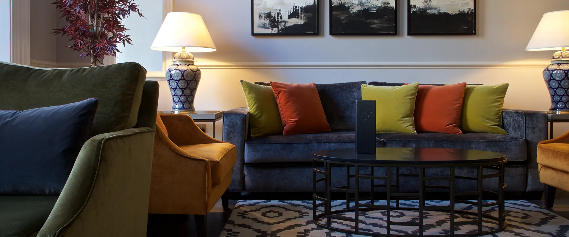 Modern living room with colorful pillows and a cozy atmosphere.