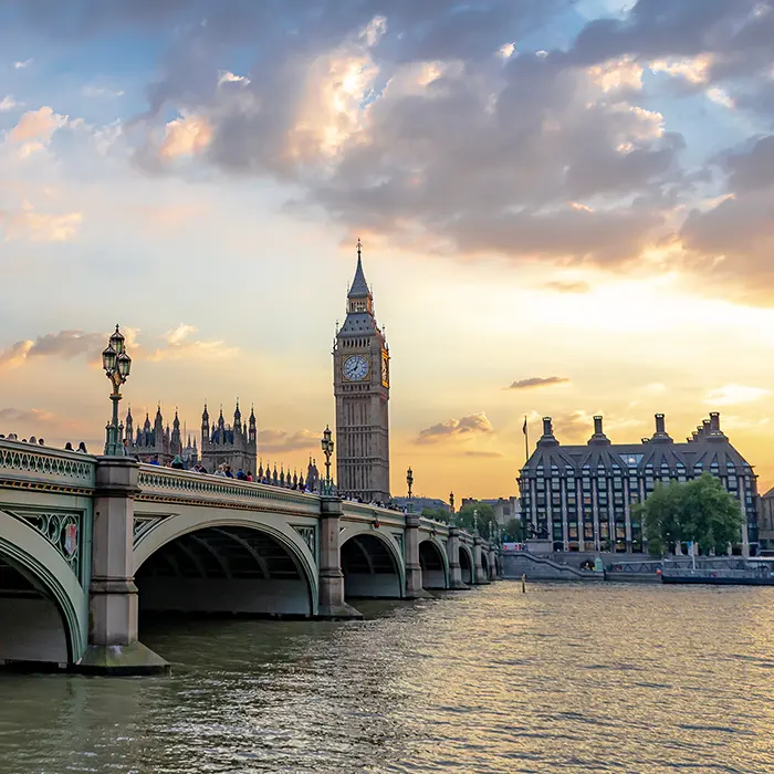 Big Ben and Westminster Bridge at sunset over the River Thames.